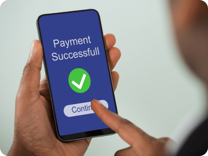 Phone in hand showing payment successful